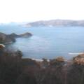 A picture of the sea from the top of a mountain look-out.